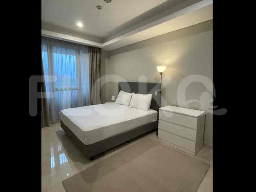 A bedroom with a queen-sized bed, dresser, and a window with curtains.