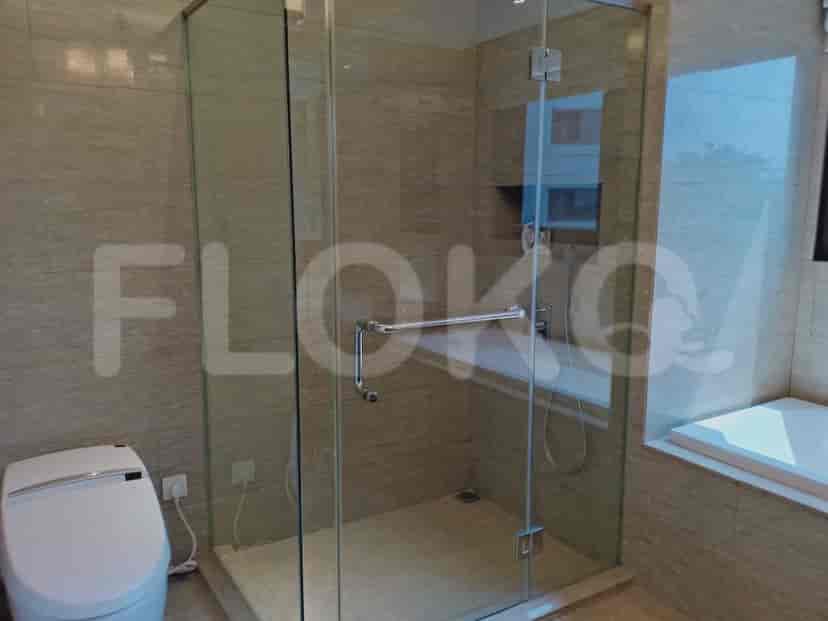 A modern bathroom with a glass-enclosed shower, a sleek toilet, and a bathtub.