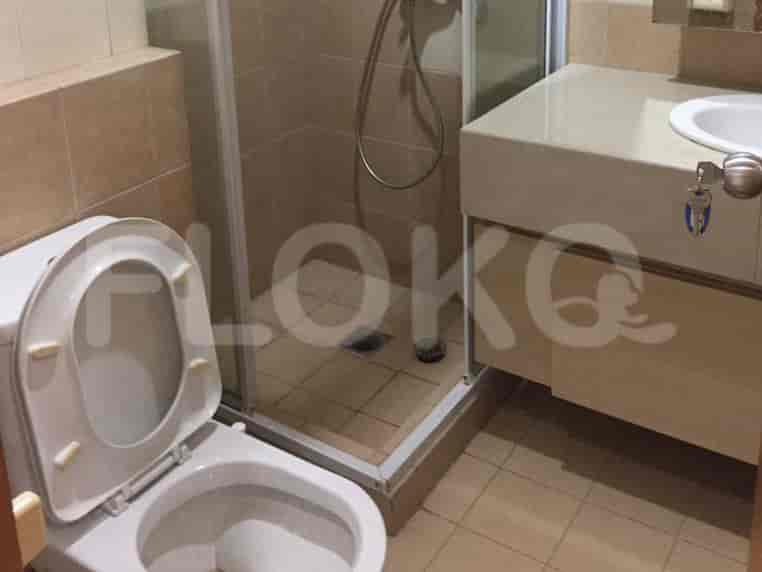 Bathroom with a toilet, shower, and sink.