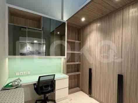 A compact area with a desk, chair, and storage units.