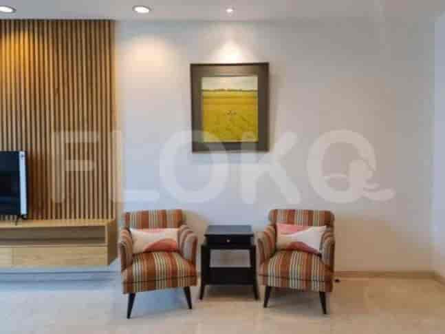 A cozy living area with two armchairs and a decorative artwork.