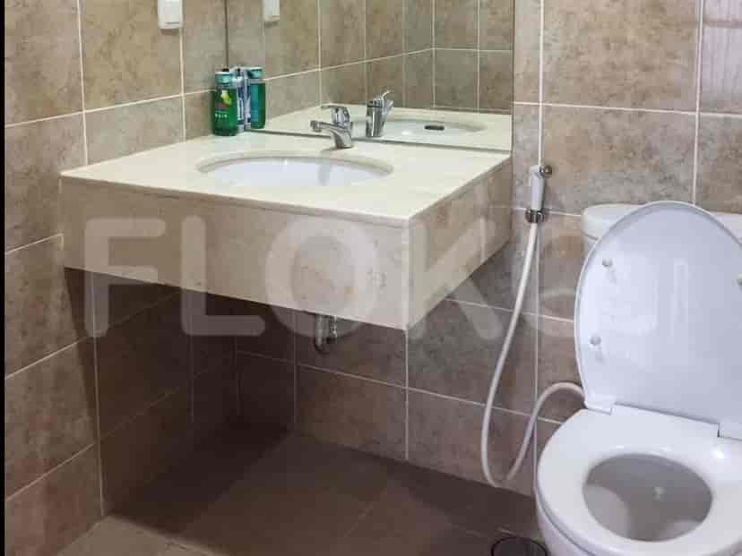 Bathroom with a sink, mirror, and toilet.