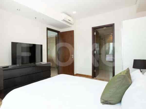 Bedroom featuring a bed, dresser, and access to a bathroom.
