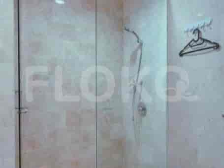 A bathroom with a glass shower and marble.