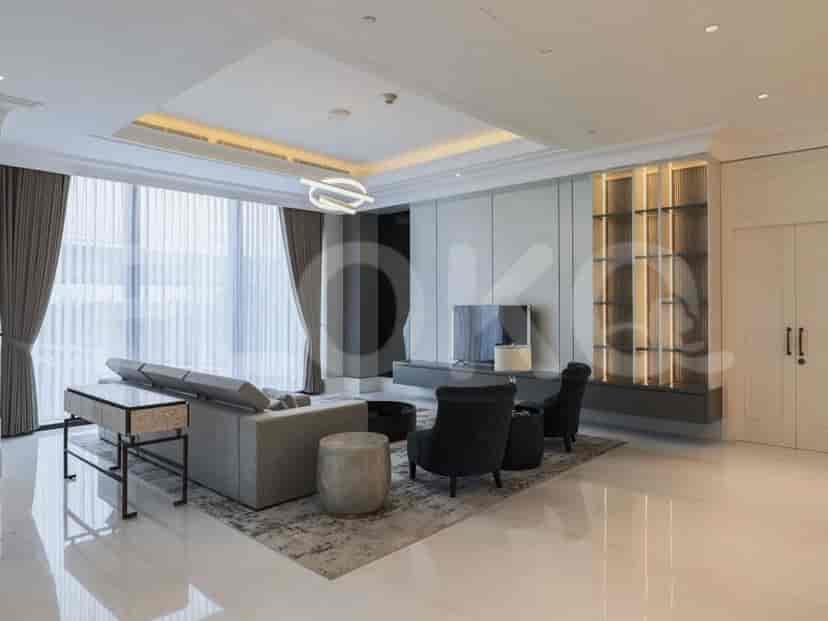 Another angle of the living room, showcasing the integrated media unit and additional seating.