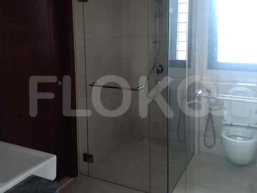 A bathroom with a shower, a sink and a toilet.