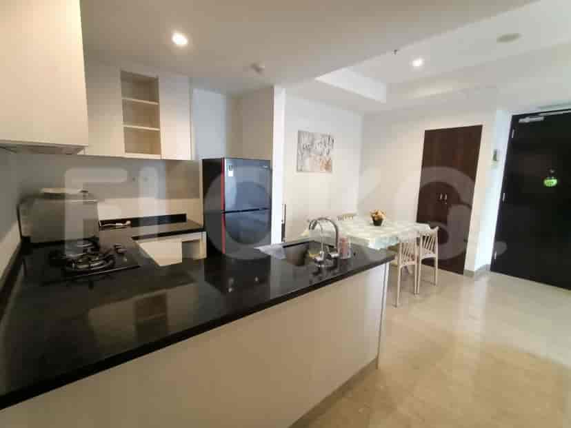 A modern kitchen and dining area with a black countertop.