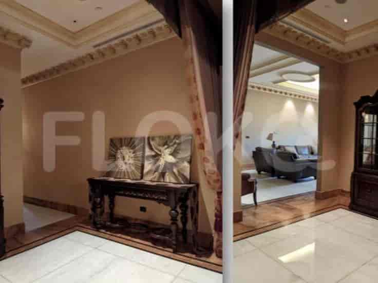Hallway with decorative elements, including artwork and ornate ceiling details.