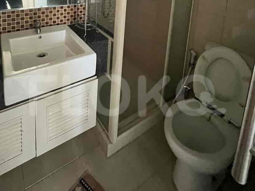 A modern bathroom with a toilet, sink, and shower.