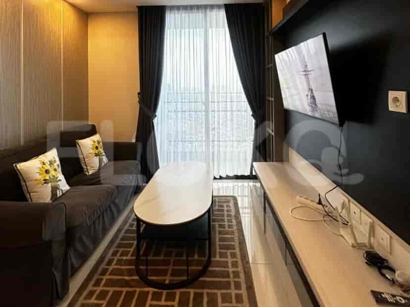 A cozy living room with a dark grey sofa, a white marble coffee table, a wall-mounted TV, and large windows with curtains.
