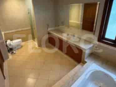 A spacious bathroom with a bathtub, a double vanity, and a separate toilet area.