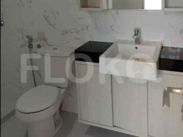 A bathroom with a toilet, sink, and vanity.