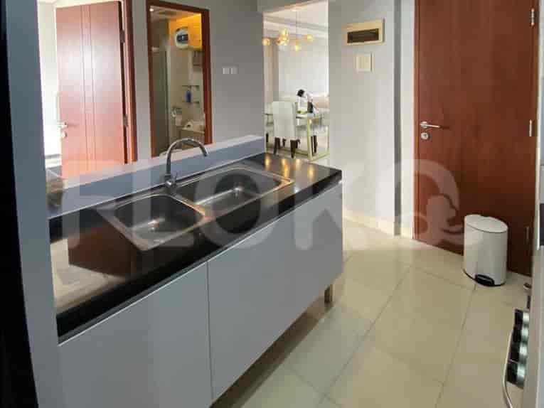A modern kitchen with stainless steel appliances and dark countertops.