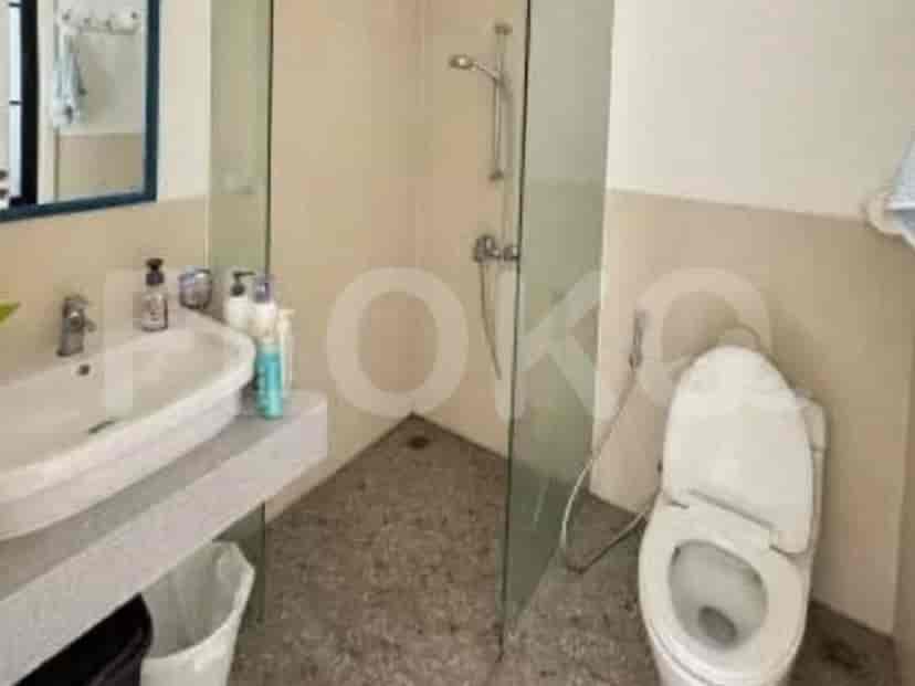 A bathroom with a sink, toilet, and a walk-in shower with a glass enclosure.