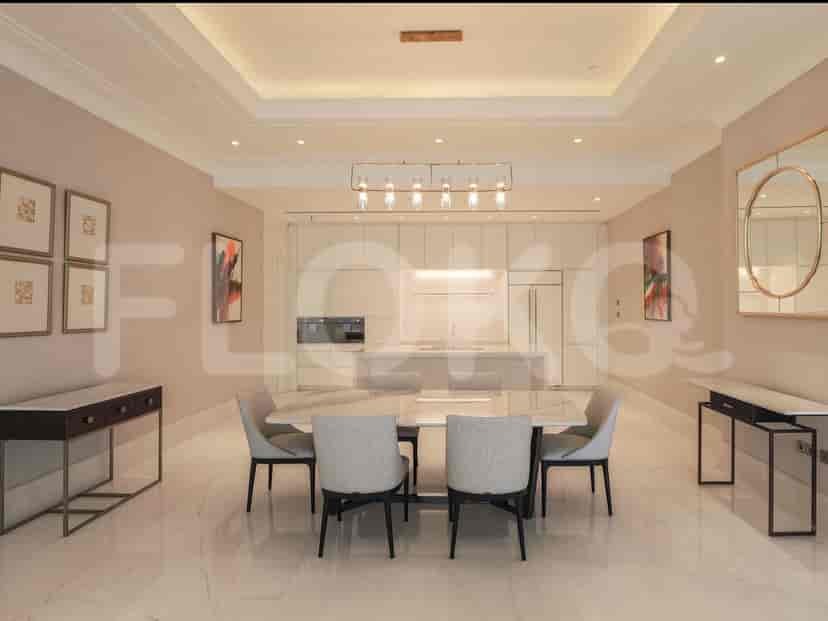 An elegant dining room with a marble dining table, modern light fixtures, and stylish decor.