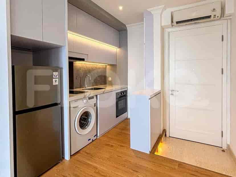 Modern kitchen with appliances including a refrigerator, washing machine, and oven.