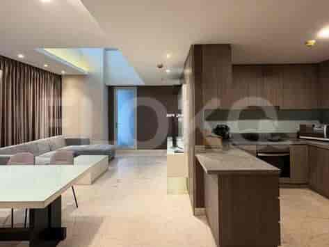 A bathroom with a toilet, sink, and shower area.