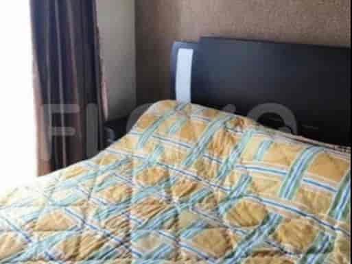 Bedroom with a bed, nightstand, and patterned bedspread.