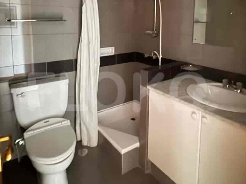 A bathroom with a toilet, a shower stall, a sink, and a vanity.