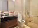 A clean bathroom with a toilet, sink, and vanity.