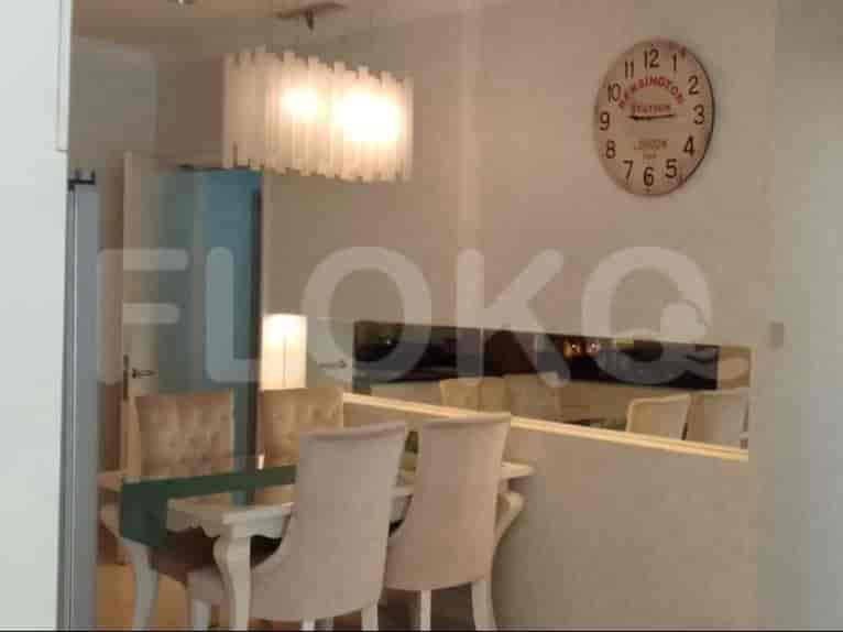 Dining table with chairs under a chandelier.