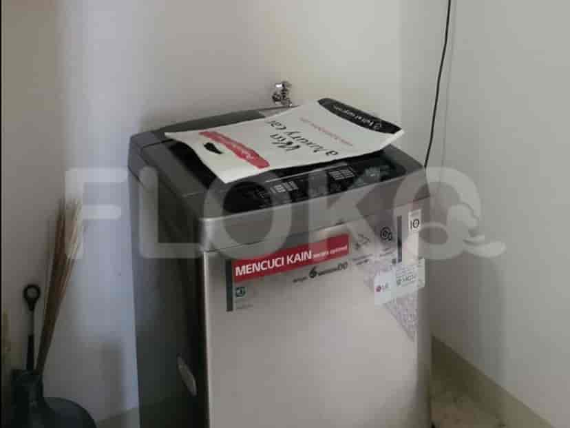Laundry area with a washing machine.