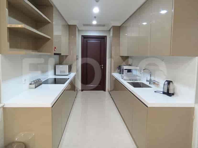 A modern, closed kitchen with sleek cabinetry and integrated appliances.