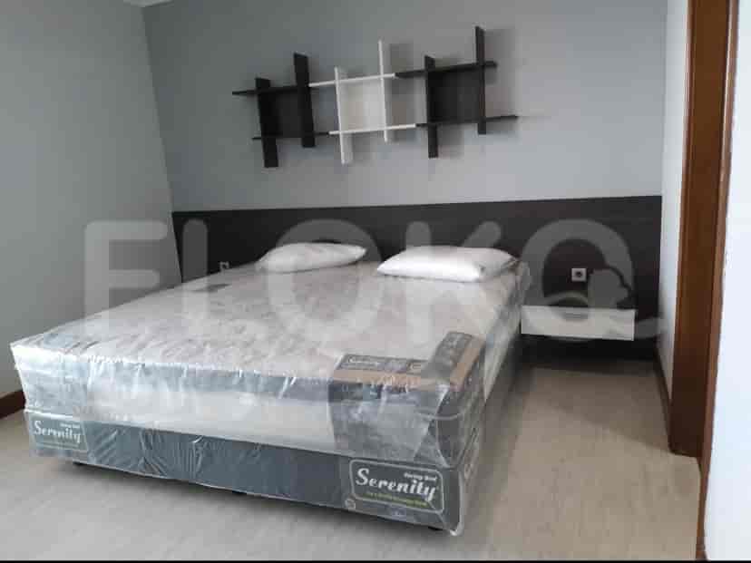 Bedroom with a double bed, nightstands, and a wall-mounted shelf unit.