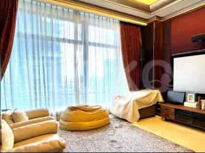 Living room with large window, red drapes, sofa, and entertainment setup.