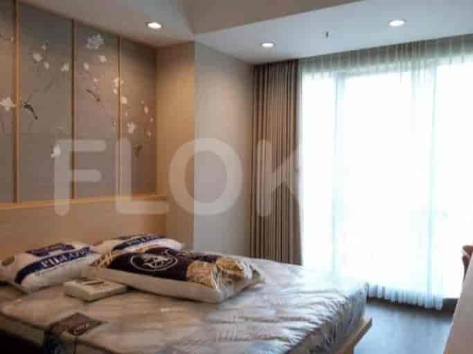 Bedroom with a bed and large window.