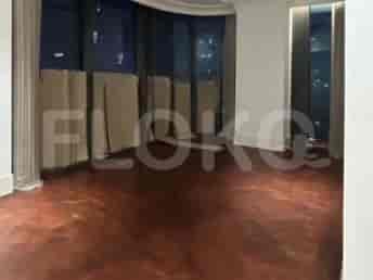 A spacious living room with white walls, marble floors, and a large window with automated roller blinds.