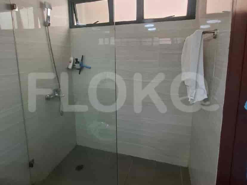 A modern bathroom with a glass-enclosed shower.