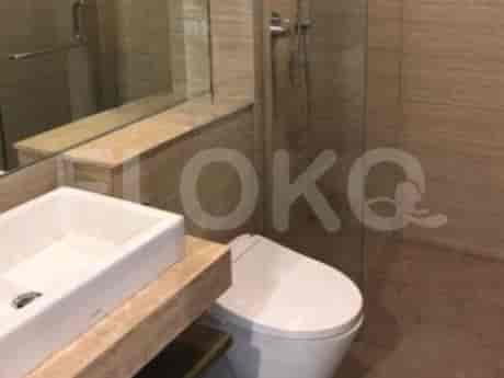 A modern bathroom with a white toilet and sink.