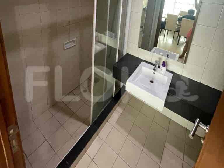 A bathroom with a shower stall, a sink vanity, and a mirror.