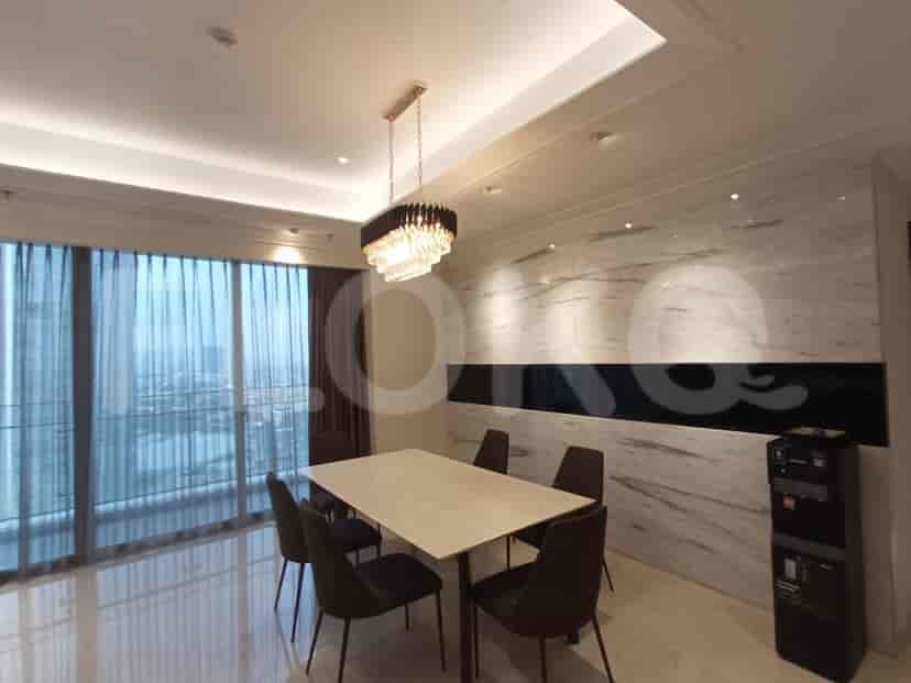 A dining room with a rectangular table, four chairs, and a crystal chandelier.