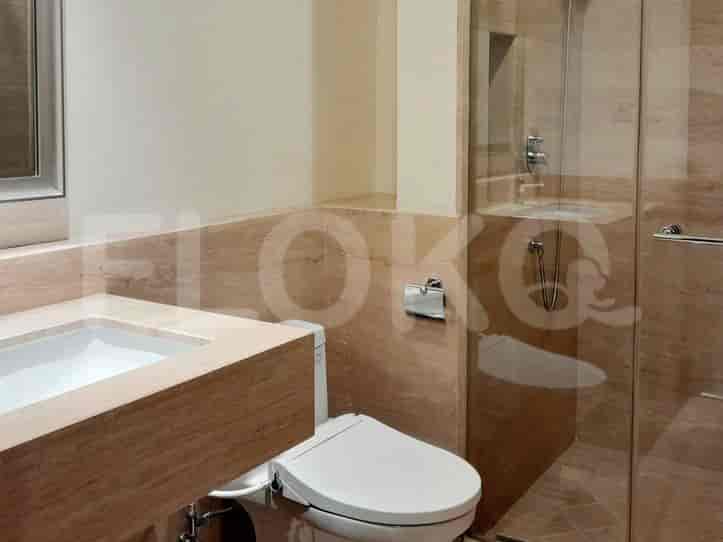 A modern bathroom with a vanity, toilet with bidet, and a glass-enclosed shower.