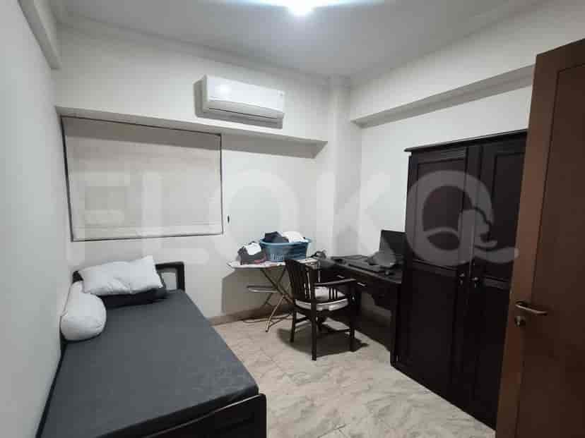 A smaller bedroom or study room with a single bed, desk, and wardrobe.