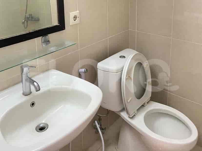 A well-lit bathroom with a sink and a toilet.