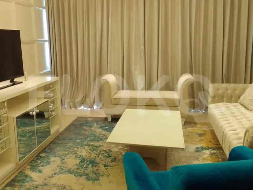 Living room view with a TV cabinet and seating.