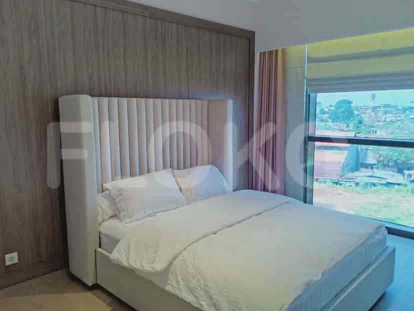 A bedroom featuring a king-size bed with a tall headboard, wooden accent wall, and large window.