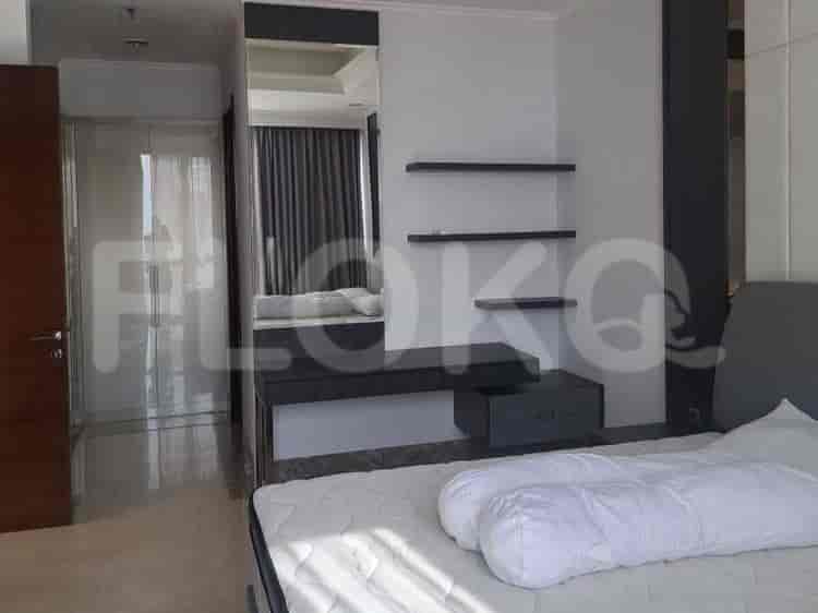A modern bedroom with a large bed and built-in wardrobe.