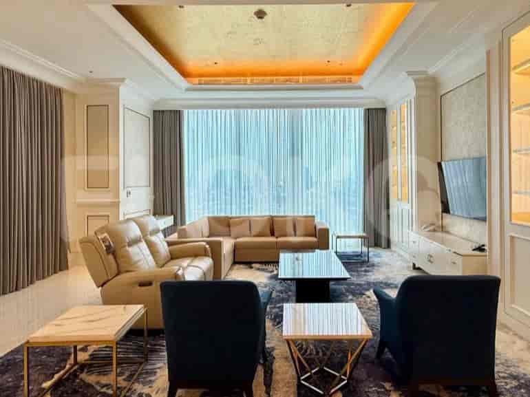 A large living room with a sectional sofa, coffee tables, chairs, and a large window with curtains.