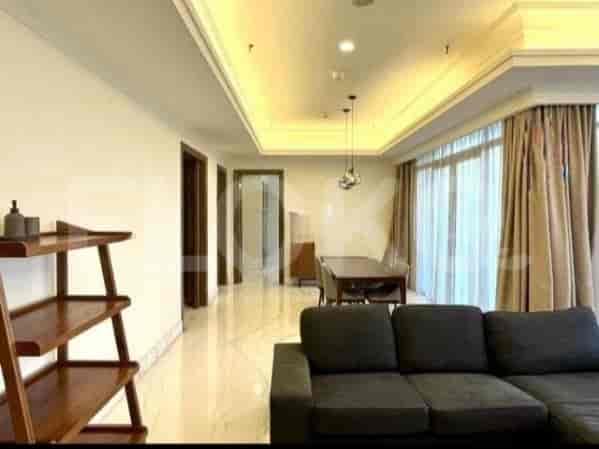 Open-plan living and dining area with a sofa and dining table.