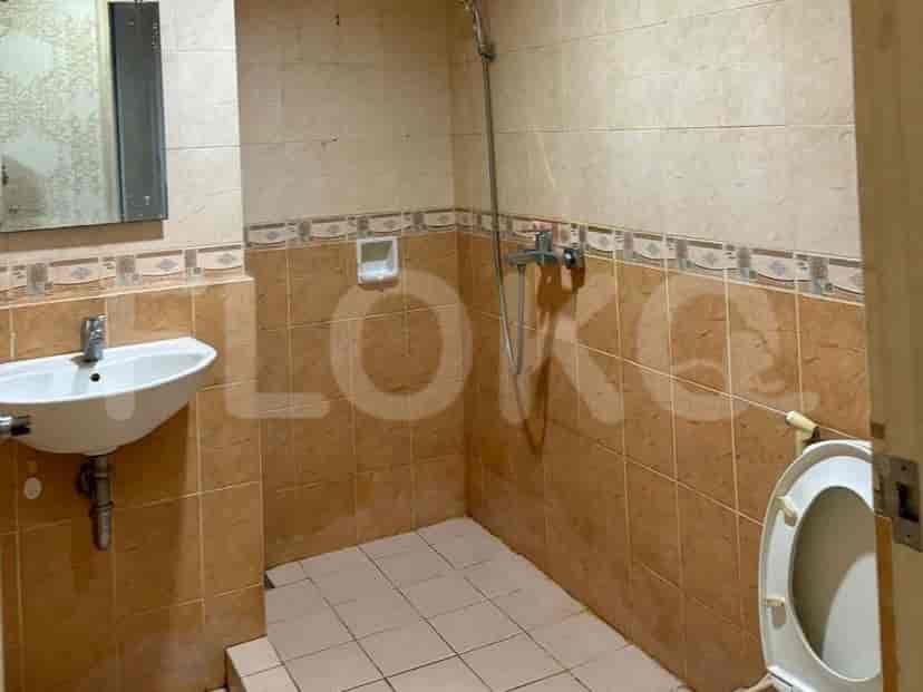 A bathroom with a sink and tiled walls.