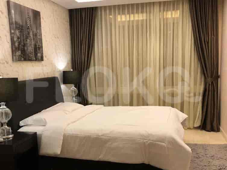 Another bedroom view with a large bed, bedside tables, and lamps.