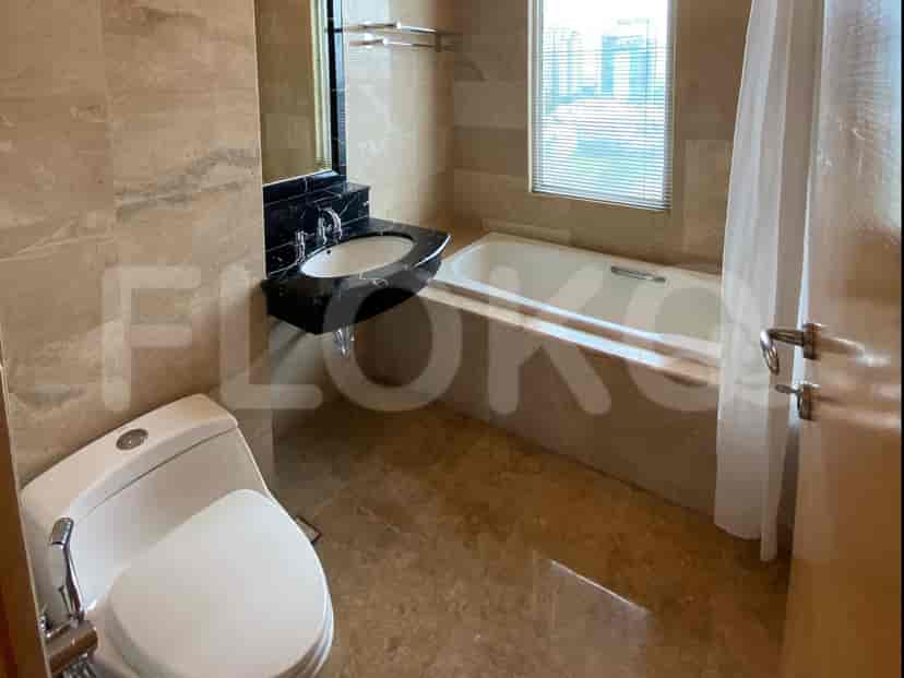 A laundry area with a washing machine, dryer, and access to the balcony.