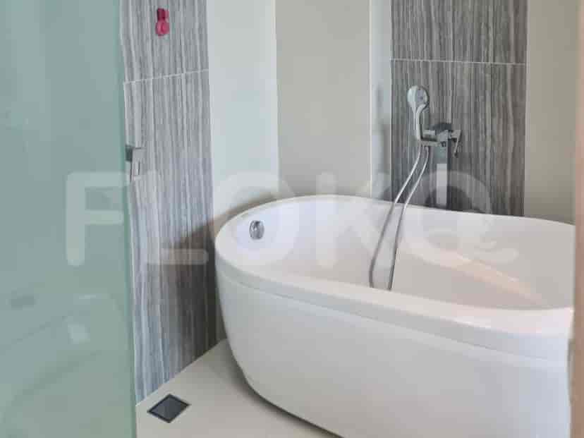 A bathroom with a bathtub and a glass shower.
