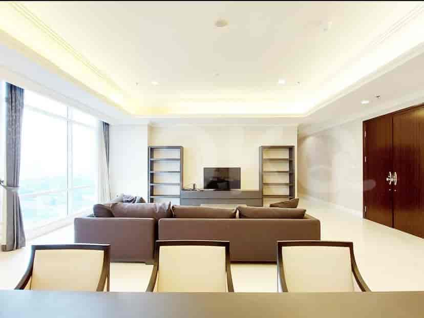 Living room with central TV unit and two bookshelves.