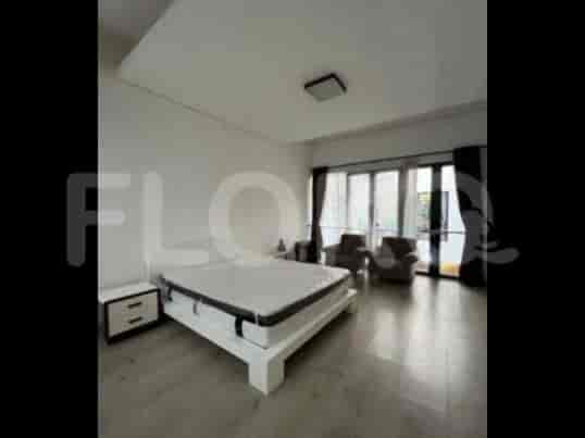 A modern bedroom featuring a king-size bed, a bedside table with a lamp, and a large window.