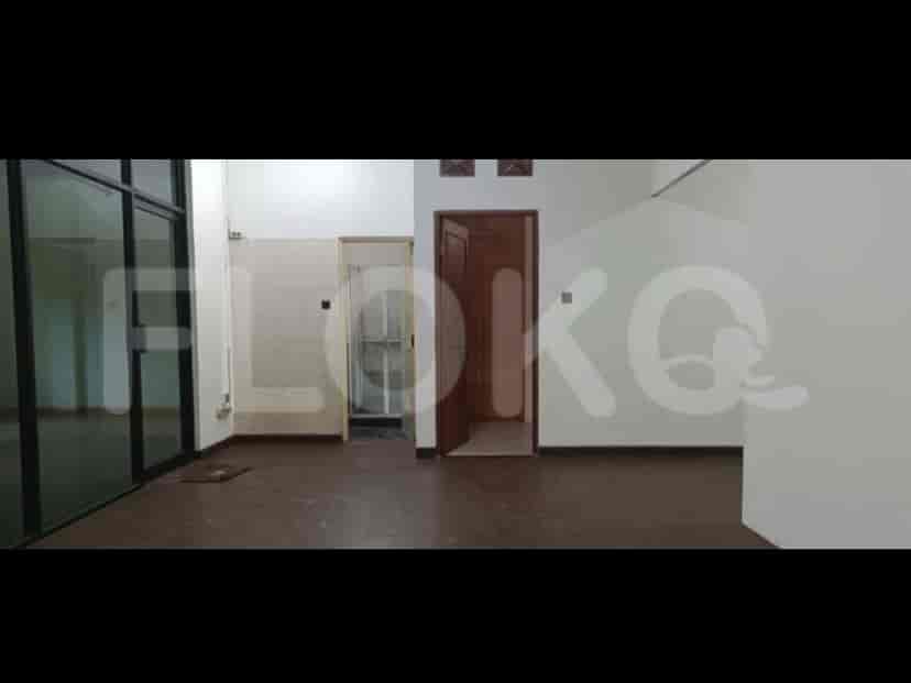 Interior view with a door leading to a bathroom and a door leading to another room. The room has dark wooden flooring.